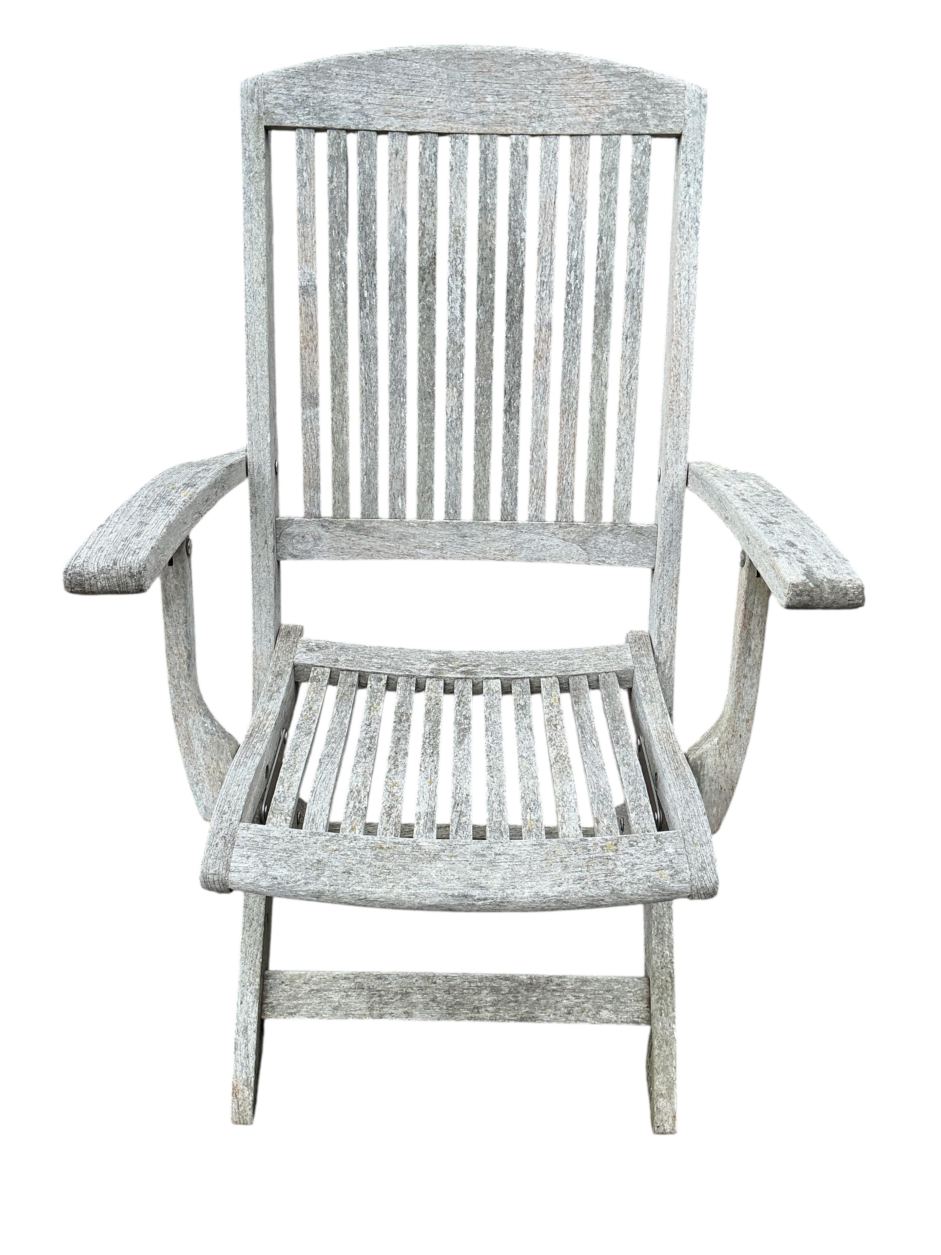 An Indian Ocean Trading Company rectangular teak extending garden table, width 164cm, depth 90cm, height 74cm, four folding chairs and a canvas parasol with metal stand